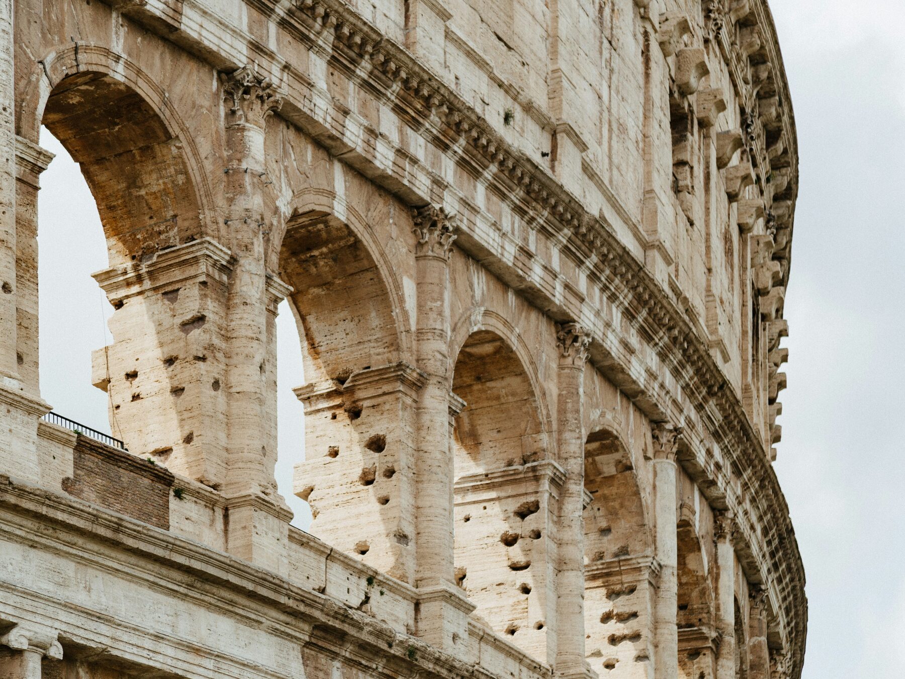 The Colosseum's outer ring, still standing over the ground the enrollment names.