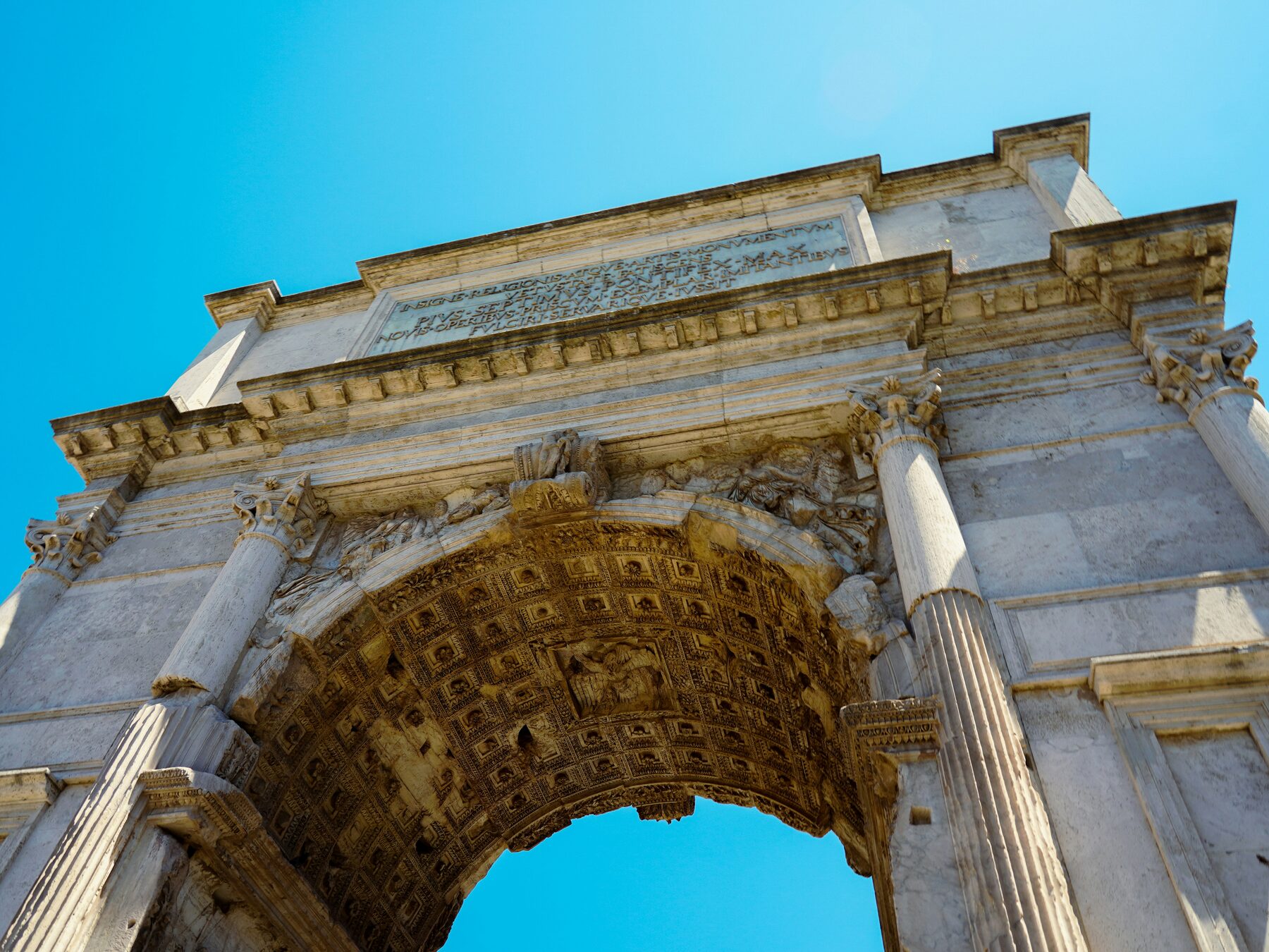 The Arch of Titus: imperial stone, and the arches and vaults that carried the Pax Romana.