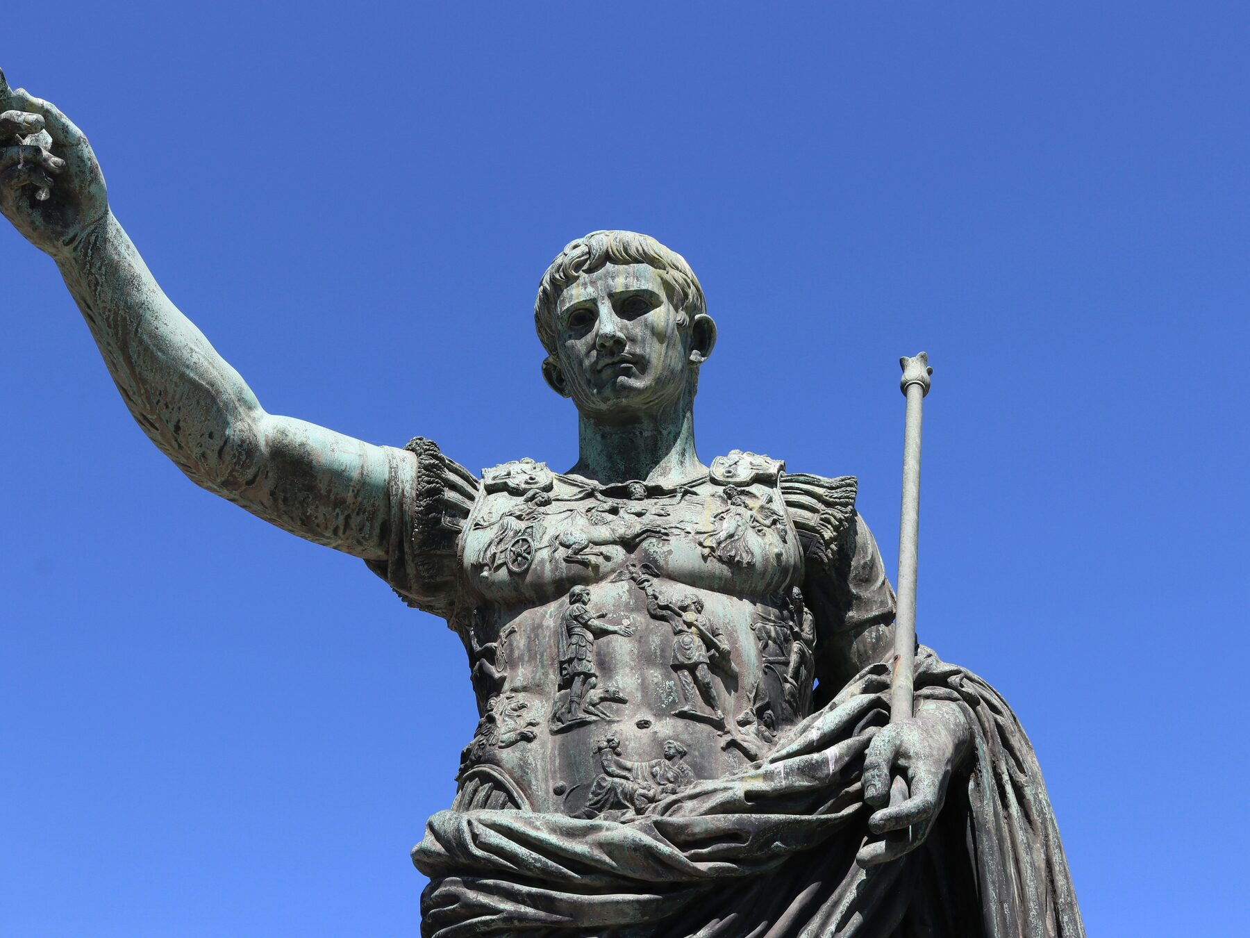 Augustus in bronze on the Via dei Fori Imperiali, pointing the way the Republic did not want to go.