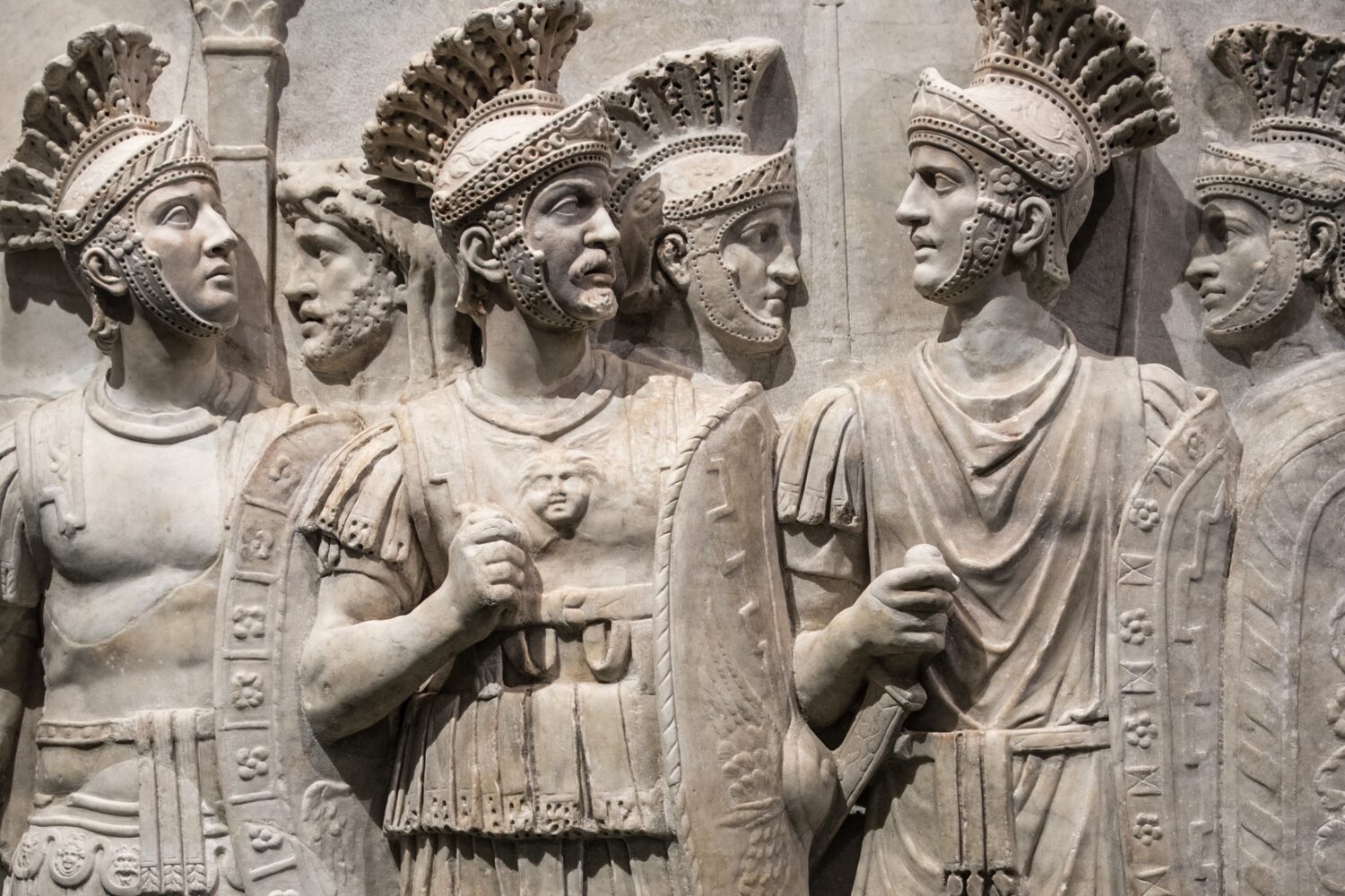 Crested helmets, oval shields and an eagle standard above them: the carved marble long known as the Praetorian Relief.